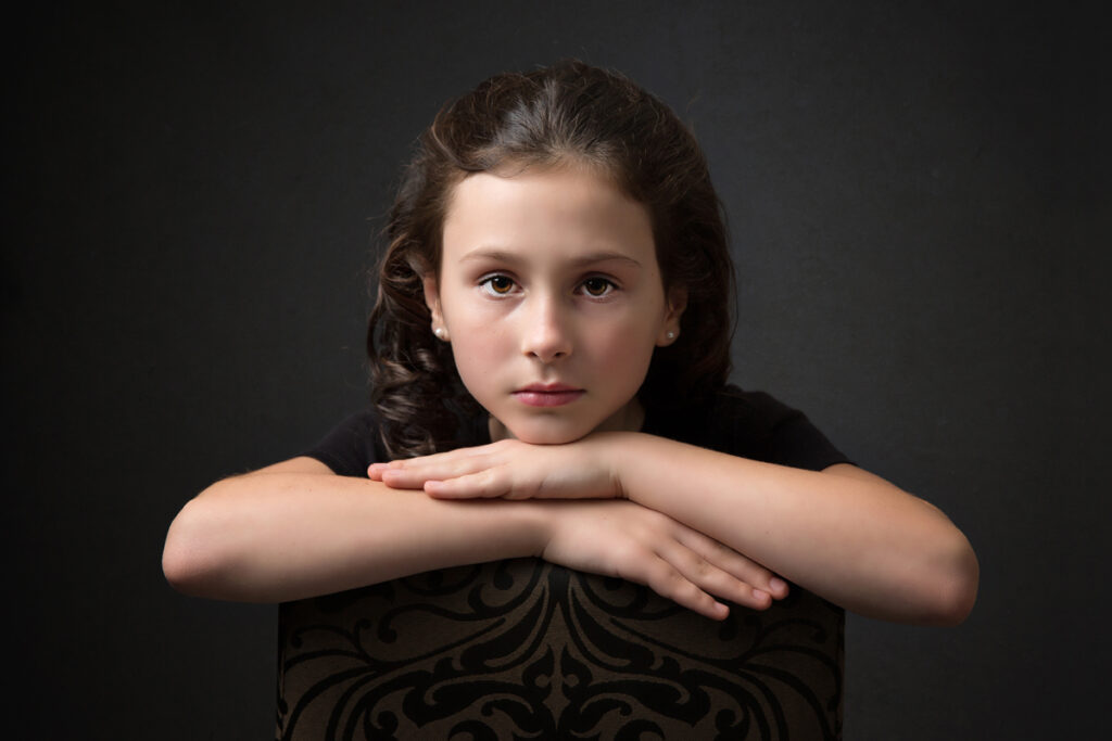 Young girl with dark posing on a chair Hilton Photography photo shoot